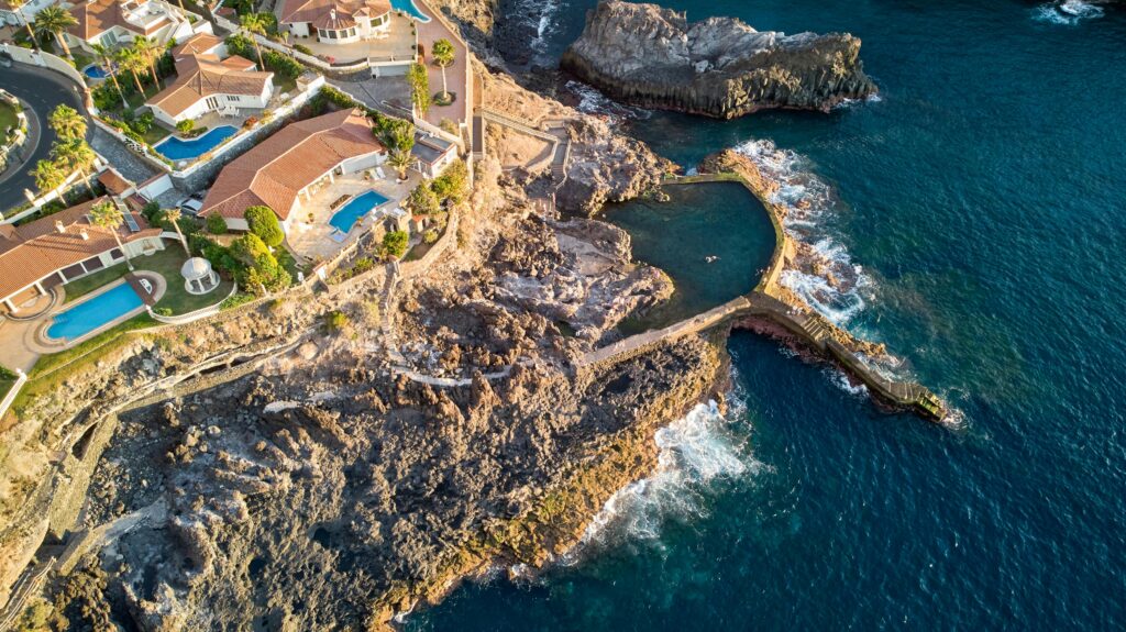 Stunning aerial view of Santiago del Teide's rocky coast and villas.
