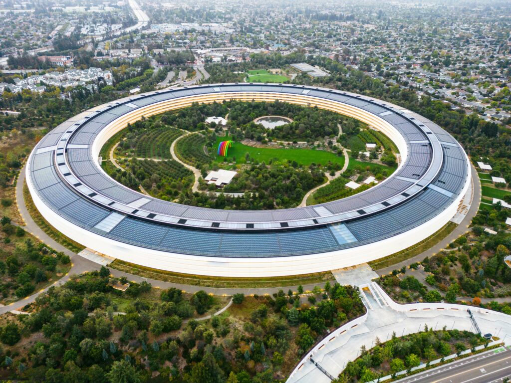 pexels-photo-13633184-13633184 Stunning aerial view of the modern Apple Park in Cupertino, showcasing its unique circular design and lush greenery.