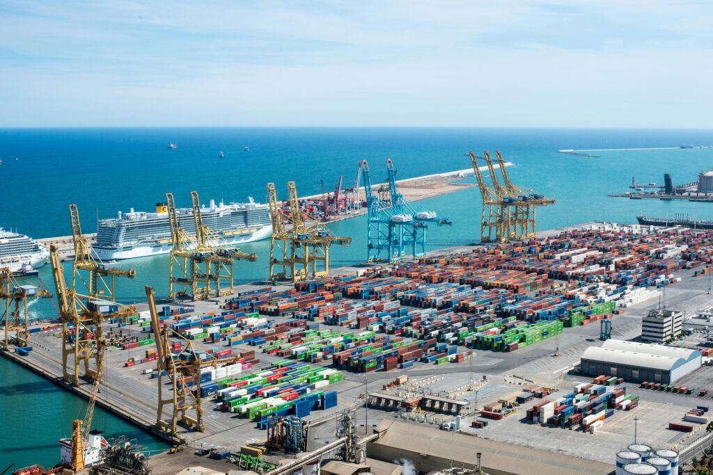 pexels-photo-16857407-16857407 A vibrant aerial shot of Barcelona port featuring cranes, containers, and cruise ships on a sunny day.