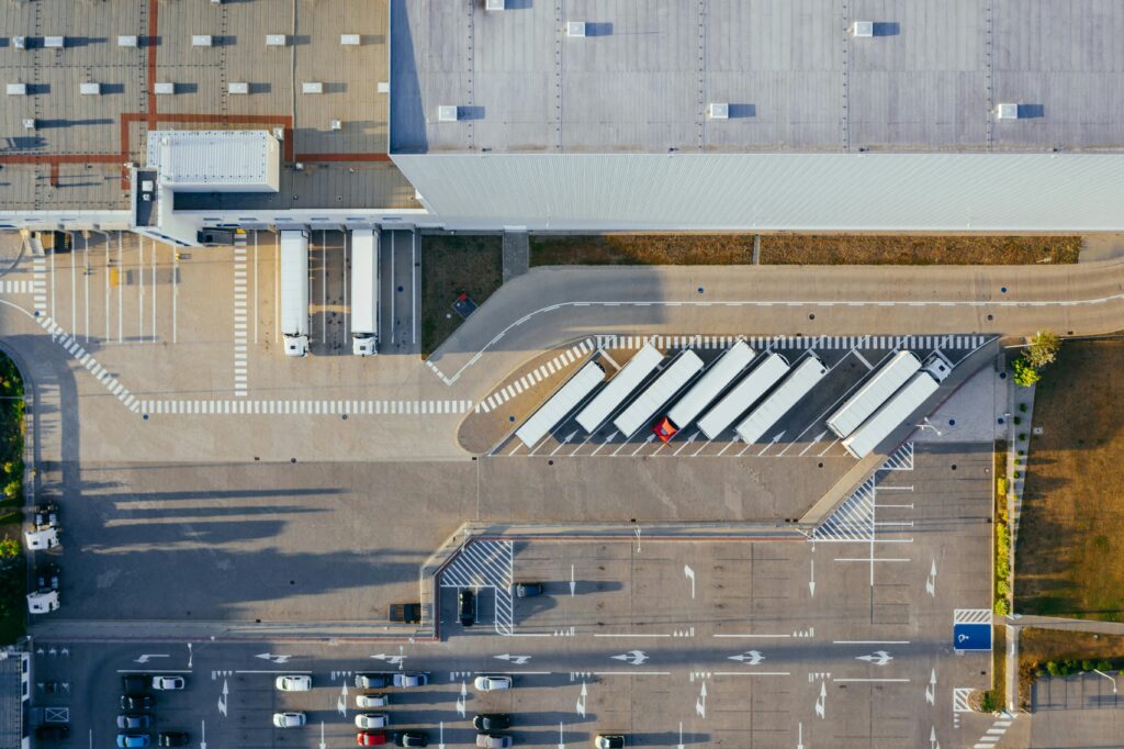 pexels-photo-2804929-2804929 Drone shot of a logistics center with trucks and parking lot in Poznań, Poland.