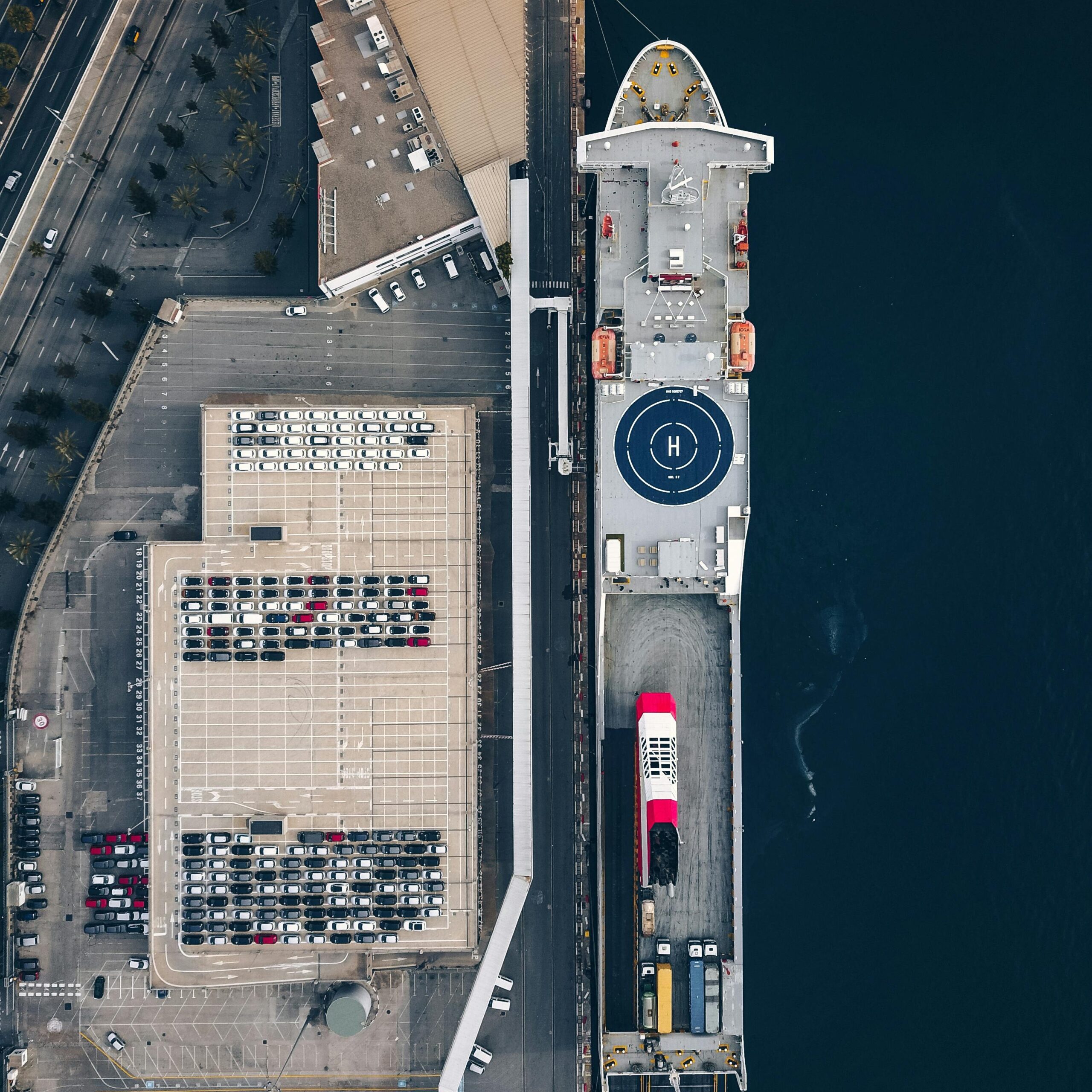 pexels-photo-9022662-9022662 Aerial shot of a cargo ship docked at Barcelona port, showcasing the harbor's industrial setup.